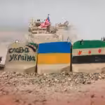Concrete blocks with the Ukrainian flag and HTS' fake Syrian flag painted on them, along with pro-Ukraine and pro-separatist slogans. Photo: The Cradle.