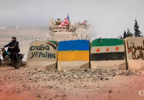 Concrete blocks with the Ukrainian flag and HTS' fake Syrian flag painted on them, along with pro-Ukraine and pro-separatist slogans. Photo: The Cradle.