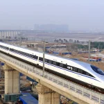 A bullet train passes over Yongdinghe Bridge in Beijing Wednesday, Dec. 26.2012. Photo: Jiao Hongtao/Xinhua.
