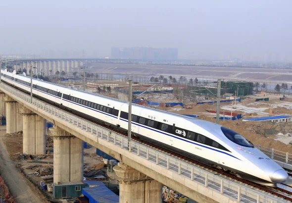 A bullet train passes over Yongdinghe Bridge in Beijing Wednesday, Dec. 26.2012. Photo: Jiao Hongtao/Xinhua.