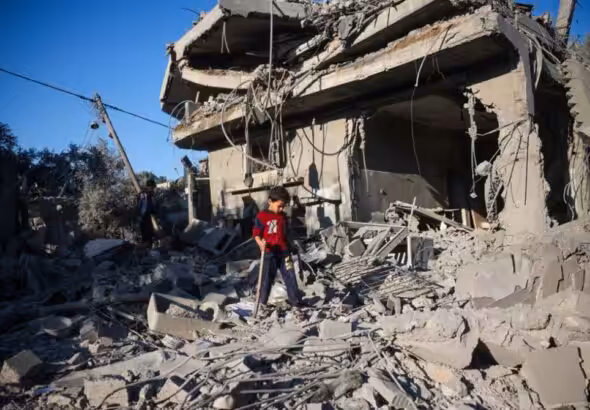 A boy walks among the rubble of a house destroyed in an Israeli strike at the Nuseirat refugee camp, in the central Gaza Strip. Photo: AFP