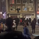 Israeli hooligans tearing down a Palestinian flag hanging on an Amsterdam building in solidarity with the Palestinian people being massacred in Gaza by the occupation entity of "Israel." Photo: X/@hel7endy.