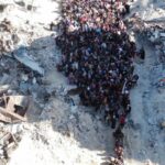 A drone image shows displaced people at an 'Israeli' checkpoint as they are forced to flee Jabalia. Photo: Avichay Adraee/Reuters.