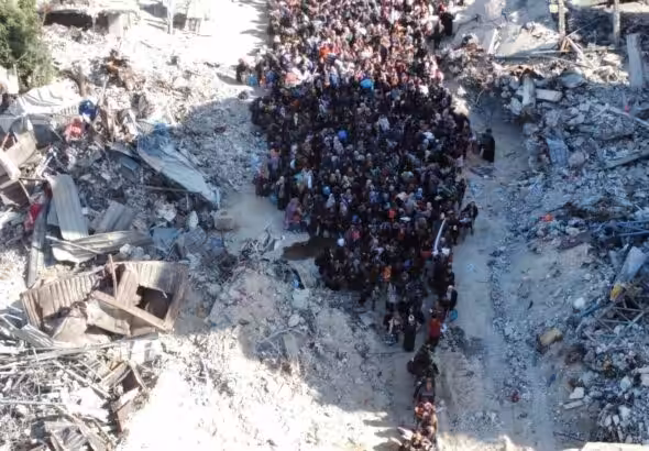 A drone image shows displaced people at an 'Israeli' checkpoint as they are forced to flee Jabalia. Photo: Avichay Adraee/Reuters.