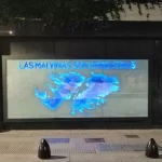 A banner shows the map of the Malvinas Islands with colors of the flag of Argentina, with the words "The Malvinas Are Argentinian," at a memorial for the fallen soldiers of the Malvinas War. Photo: Sputnik/Samuel Cortés Hamdan.