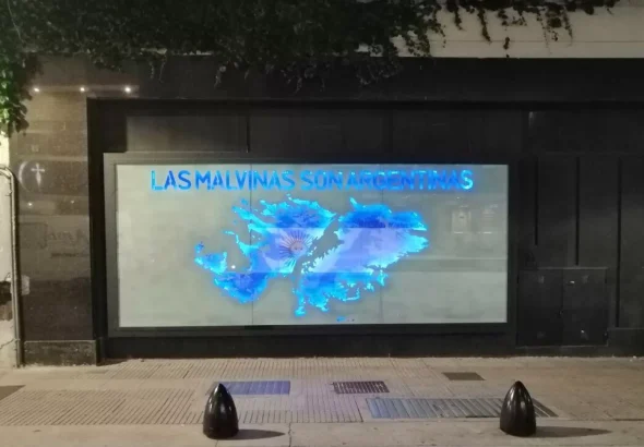 A banner shows the map of the Malvinas Islands with colors of the flag of Argentina, with the words "The Malvinas Are Argentinian," at a memorial for the fallen soldiers of the Malvinas War. Photo: Sputnik/Samuel Cortés Hamdan.