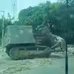An armored bulldozer known as “Satan” destroying houses in Lower Delmas on Nov. 24. Photo: Haïti Liberté.