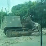 An armored bulldozer known as “Satan” destroying houses in Lower Delmas on Nov. 24. Photo: Haïti Liberté.