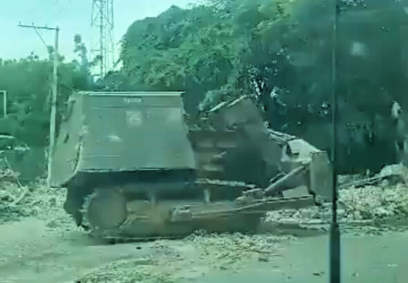 An armored bulldozer known as “Satan” destroying houses in Lower Delmas on Nov. 24. Photo: Haïti Liberté.