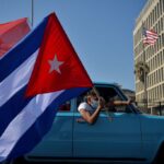 Cubans drive past the US embassy during a rally calling for the end of the US blockade. Photo: Yamil Lage/AFP.