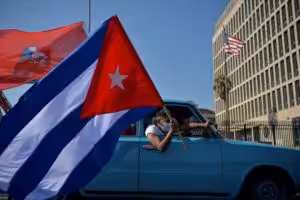 Cubans drive past the US embassy during a rally calling for the end of the US blockade. Photo: Yamil Lage/AFP.