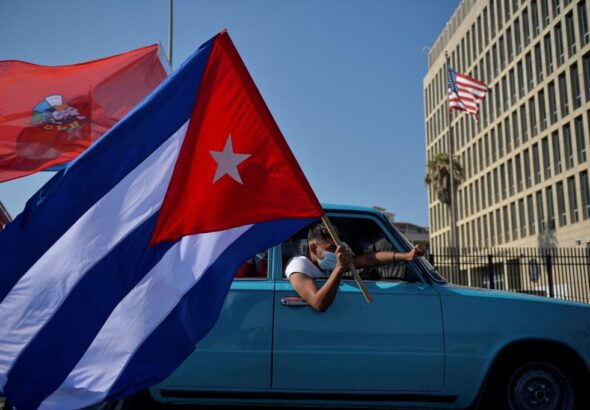 Cubans drive past the US embassy during a rally calling for the end of the US blockade. Photo: Yamil Lage/AFP.