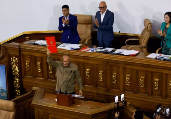 Member of the National Assembly and Vice president of the United Socialist Party of Venezuela (PSUV) Diosdado Cabello, holds the recently approved bill regulating non-governmental organizations (NGOs), during an ordinary session in Caracas, Venezuela August 15, 2024. Photo: Leonardo Fernandez/Reuters.
