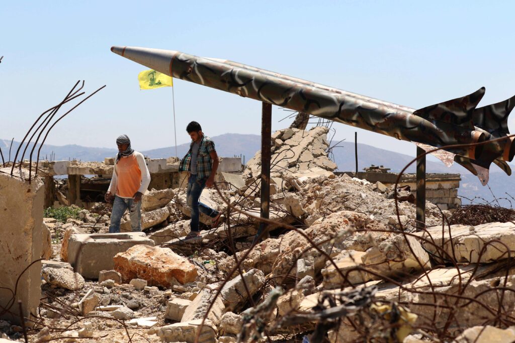 Youths walk in Khiam, Lebanon, past Hezbollah's mock rockets at the former Zionist prison that was destroyed in the 2006 war. Photo: Mahmoud Zayyat/Agence France-Presse.