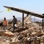 Youths walk in Khiam, Lebanon, past Hezbollah's mock rockets at the former Zionist prison that was destroyed in the 2006 war. Photo: Mahmoud Zayyat/Agence France-Presse.