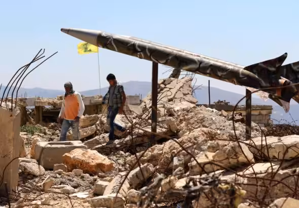Youths walk in Khiam, Lebanon, past Hezbollah's mock rockets at the former Zionist prison that was destroyed in the 2006 war. Photo: Mahmoud Zayyat/Agence France-Presse.