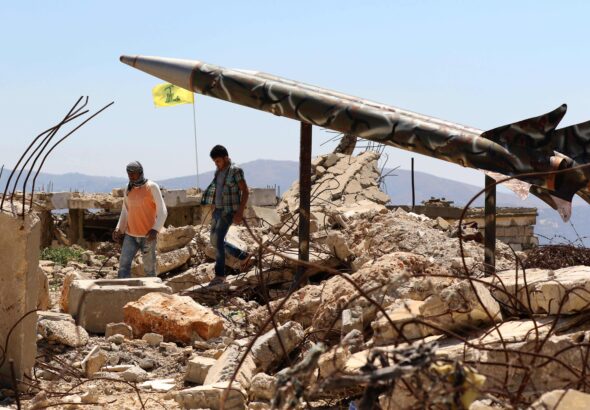 Youths walk in Khiam, Lebanon, past Hezbollah's mock rockets at the former Zionist prison that was destroyed in the 2006 war. Photo: Mahmoud Zayyat/Agence France-Presse.