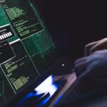 Featured image: A person types on a keyboard in front of a monitor with several open command windows.