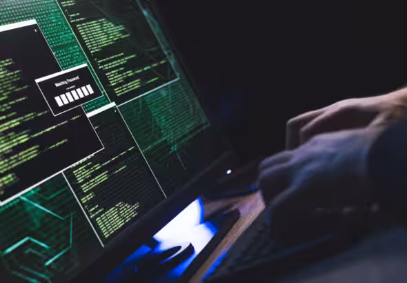 Featured image: A person types on a keyboard in front of a monitor with several open command windows.