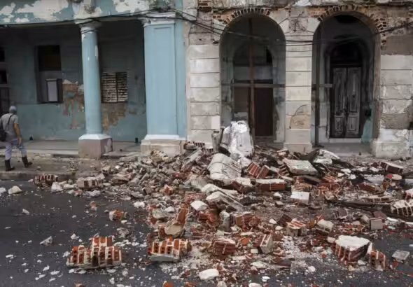 Debris from a building damaged by Hurricane Rafael covers the street in Havana, Cuba. Photo: Ariel Ley/AP.