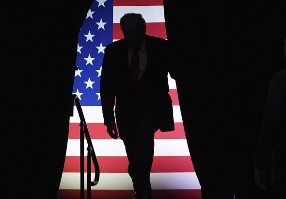 Silhouette of Donald Trump with a US flag in the background. Photo: Alba Ciudad/agencies.
