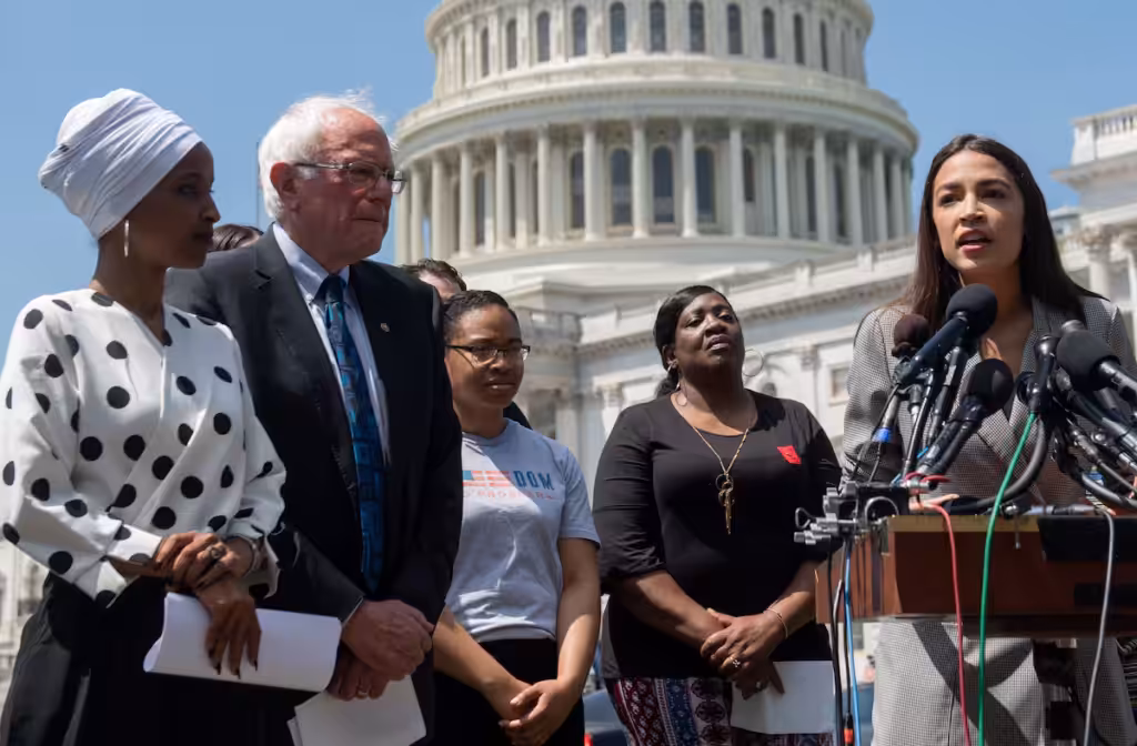 Rep. Alexandria Ocasio-Cortez (right) speaks at an event with Sen. Bernie Sanders and Rep. Ilhan Omar (left) outside the US Capitol in June. Photo: Saul Loeb/AFP/file photo.