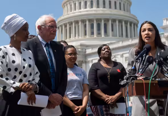Rep. Alexandria Ocasio-Cortez (right) speaks at an event with Sen. Bernie Sanders and Rep. Ilhan Omar (left) outside the US Capitol in June. Photo: Saul Loeb/AFP/file photo.