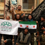 NATO-backed fighters in Idlib wave flags representing Ahrar al-Sham (left), Free Syrian Army (center), and al-Nusra Front (right) in March 2015. Photo: Reuters/Ammar Abdullah.