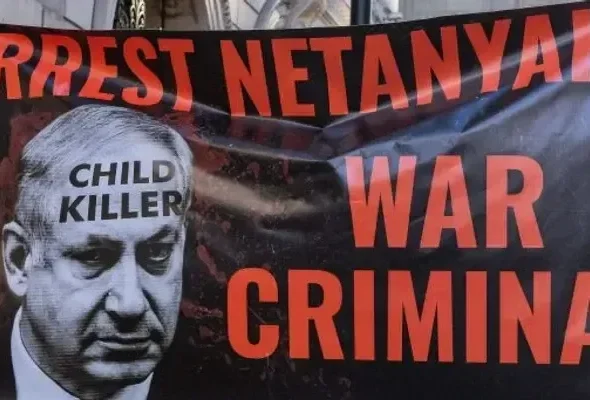 Protesters with a banner calling for Zionist prime minister Benjamin Netanyahu to be arrested march through central London to call for a permanent ceasefire in Gaza on November 25, 2023. Photo: Mark Kerrison/Common Dreams/Getty Images.
