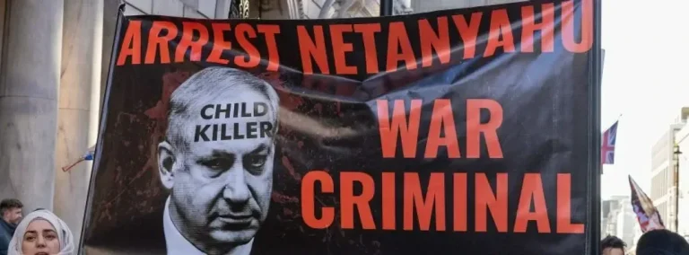 Protesters with a banner calling for Zionist prime minister Benjamin Netanyahu to be arrested march through central London to call for a permanent ceasefire in Gaza on November 25, 2023. Photo: Mark Kerrison/Common Dreams/Getty Images.