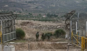 Israeli occupation forces are seen along a security fence gate near the so-called Alpha Line in the Israel occupied Syrian Golan Height, in the town of Majdal Shams, December 9, 2024. Photo: AP.