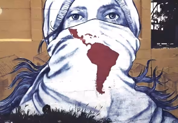 Street mural showing a face of a person crying with the face partially covered by a scarf with the map of Latin America and the Caribbean. Photo: Rebelion/file photo.