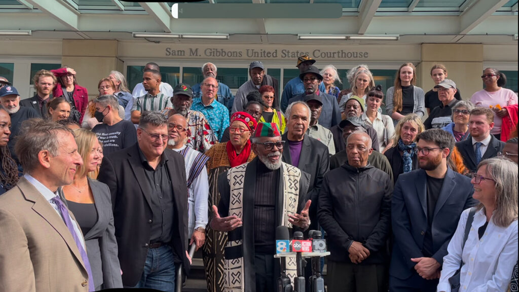 The Uhuru 3, their lawyers and supporters outside the courthouse after the sentencing hearing. Photo: Burning Spear.