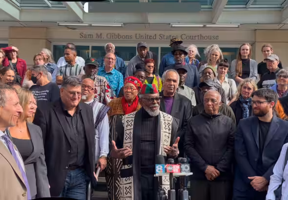 The Uhuru 3, their lawyers and supporters outside the courthouse after the sentencing hearing. Photo: Burning Spear.