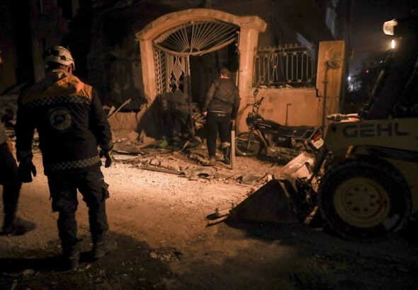 Residents inspect the site of an airstrike in Idlib, Syria, on Dec 1, 2024. Photo: AP.