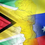 Photo composition showing the flags of Venezuela and Guyana, with a map of the Essequibo territory in between. File photo.
