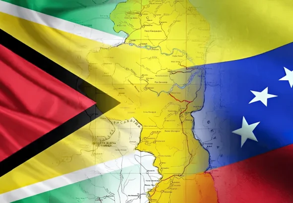 Photo composition showing the flags of Venezuela and Guyana, with a map of the Essequibo territory in between. File photo.
