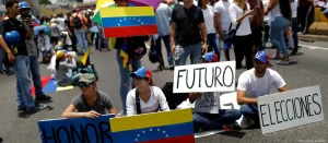 A small crowd gathers in support of María Corina Machado. Photo: C.G. Rawlins/Reuters.