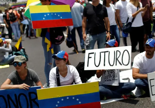 A small crowd gathers in support of María Corina Machado. Photo: C.G. Rawlins/Reuters.