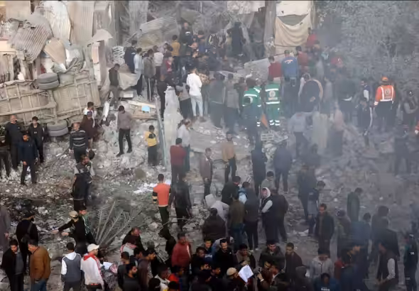 Displaced Palestinians and civil defense personnel outside the Kamal Adwan Hospital in Beit Lahia, northern Gaza, destroyed by Israeli aggression. Photo: Quds News Network.