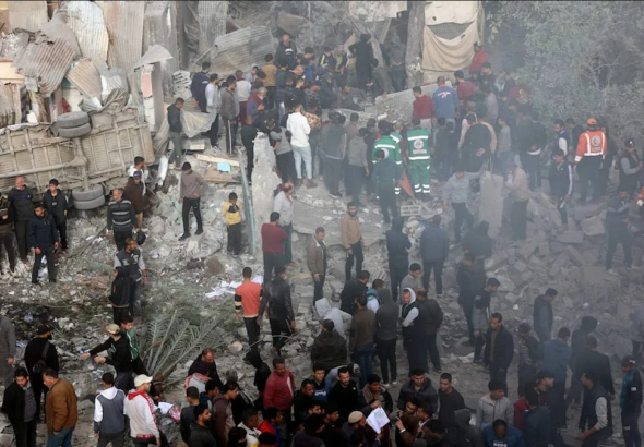 Displaced Palestinians and civil defense personnel outside the Kamal Adwan Hospital in Beit Lahia, northern Gaza, destroyed by Israeli aggression. Photo: Quds News Network.