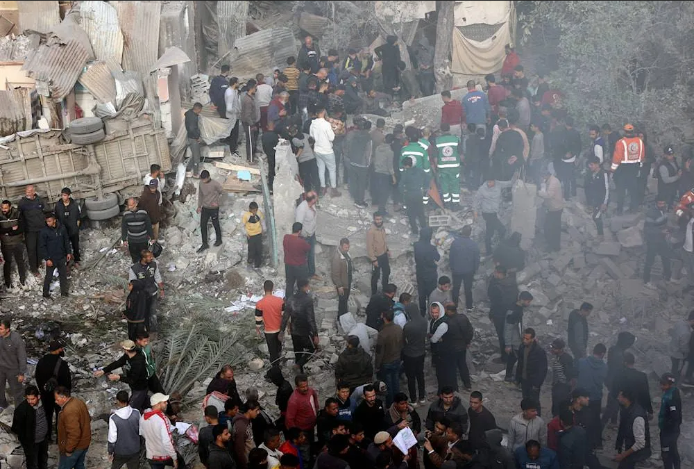 Displaced Palestinians and civil defense personnel outside the Kamal Adwan Hospital in Beit Lahia, northern Gaza, destroyed by Israeli aggression. Photo: Quds News Network.