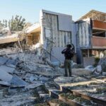 An "Israeli" Bomb Disposal Unit member inspects the rubble at a site in Ramat Gan, near Tel Aviv, impacted by fragments of a missile launched from Yemen. Photo: AFP.