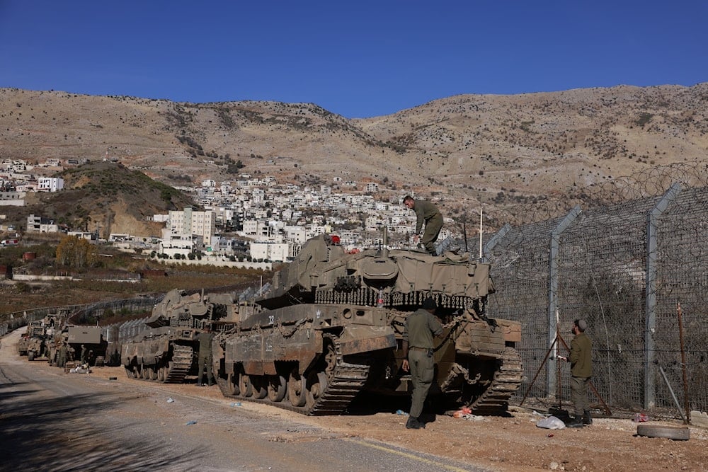 Israeli occupation armored forces take position outside the occupied village of Majdal Shams near the buffer zone that separates the occupied Golan Heights from the rest of Syria, December 9, 2024. Photo: AFP.