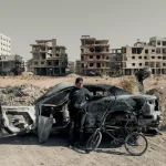 Twelve-year-old Abdulrahman collects aluminum from a destroyed car in Ghouta, Syria, on Dec. 19, 2024. Photo: Emre Caylak/Foreign Policy.