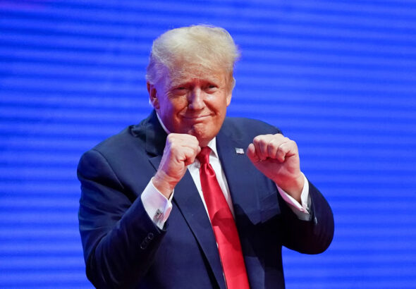 US President-elect Donald Trump making a boxing gesture at the CPAC in Florida in 2022. Photo: AP.