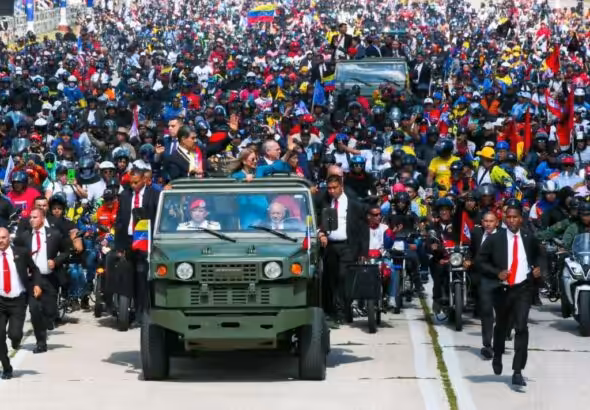 Venezuelan President Nicolas Maduro waves to supporters at the Los Proceres, Caracas, on his way to the Military Academy for a post-inauguration ceremony. He is accompany by his wife Deputy Cilia Flores and the vehicle is driven by Defense Minister Diosdado Cabello. January 10, 2025. Photo: X/@la_iguanatv.