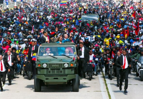 Venezuelan President Nicolas Maduro waves to supporters at the Los Proceres, Caracas, on his way to the Military Academy for a post-inauguration ceremony. He is accompany by his wife Deputy Cilia Flores and the vehicle is driven by Defense Minister Diosdado Cabello. January 10, 2025. Photo: X/@la_iguanatv.