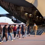 Chained migrants taken into a US military plane. Photo: X/@PressSec.