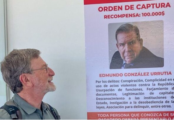 Roger D. Harris views wanted poster for González at the Caracas airport. Photo: Roger Harris.